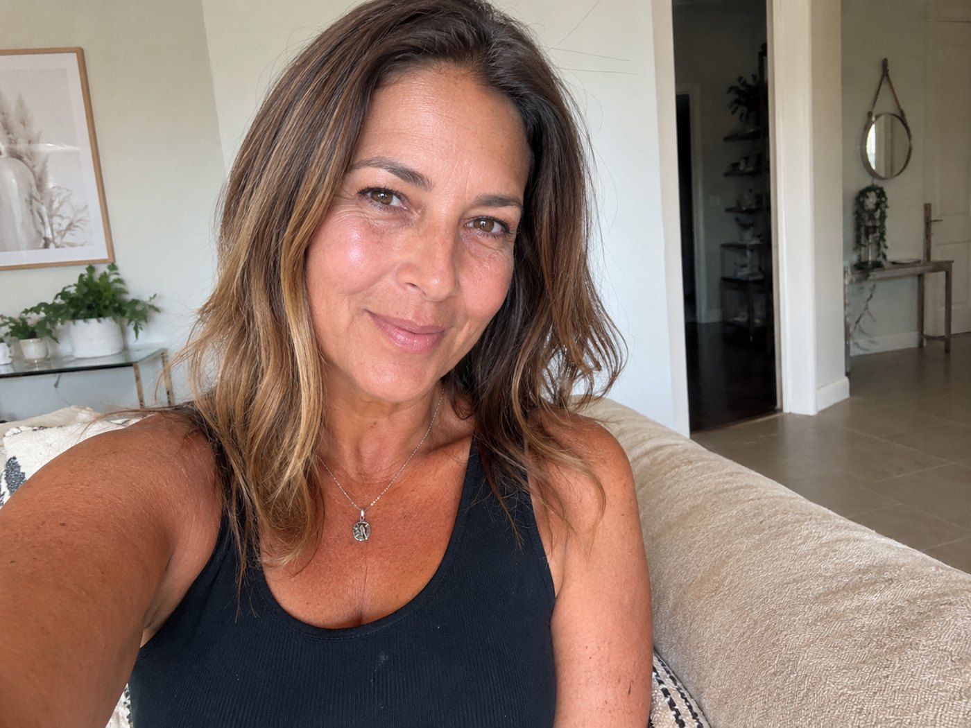 A confident woman in a sleeveless top after significant weight loss