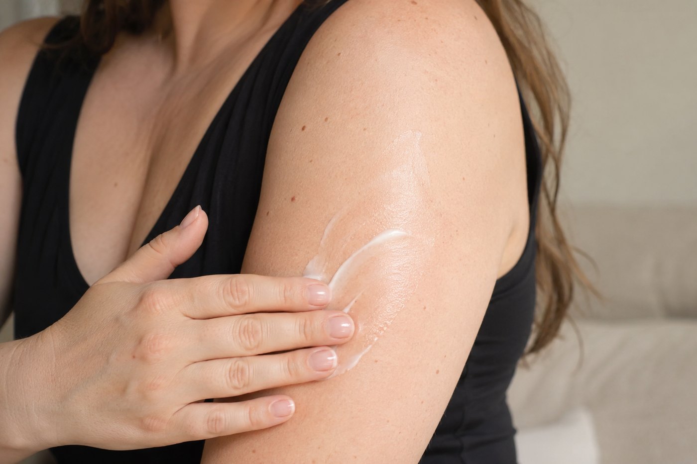 The cream being massaged into an upper arm